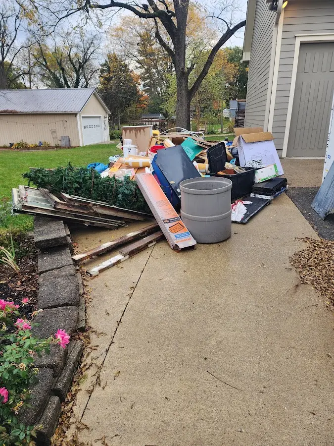 Dumpster being loaded with debris for Estate Cleanout Dumpster Rental in Canyon Lake
